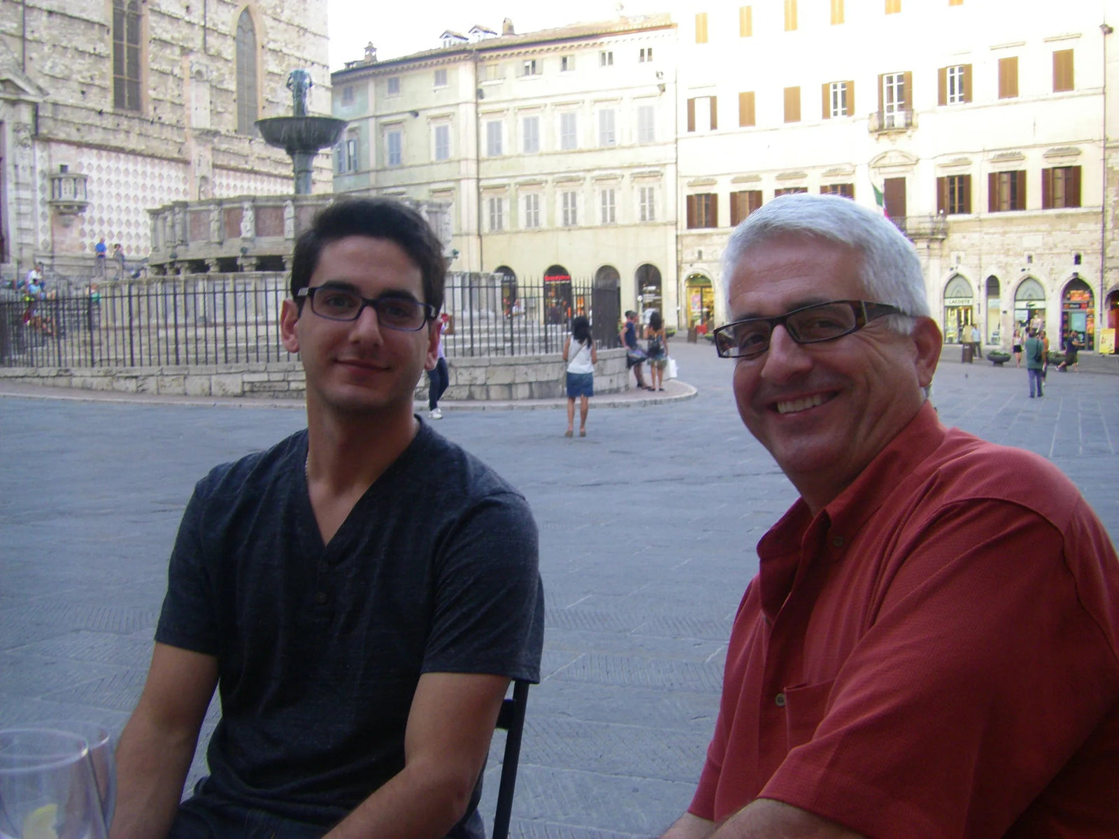 Mike and Danny seated in an Italian piazza