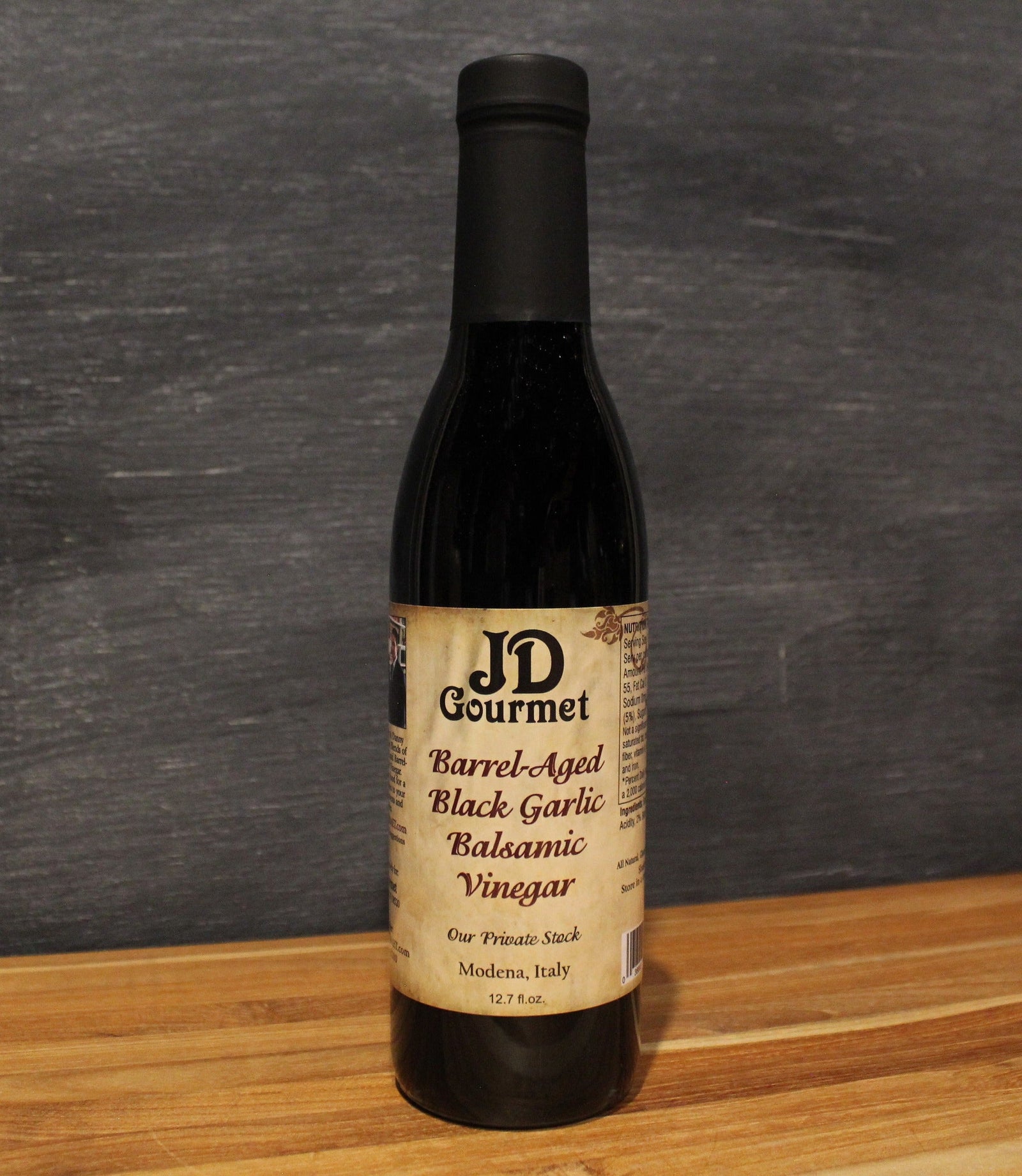 JD Gourmet Black Garlic Balsamic Vinegar bottle, dark Modena-sourced balsamic infused with black garlic