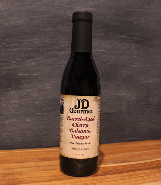JD Gourmet Cherry Balsamic Vinegar — dark glossy balsamic in a clear bottle, dark sweet cherries, Modena