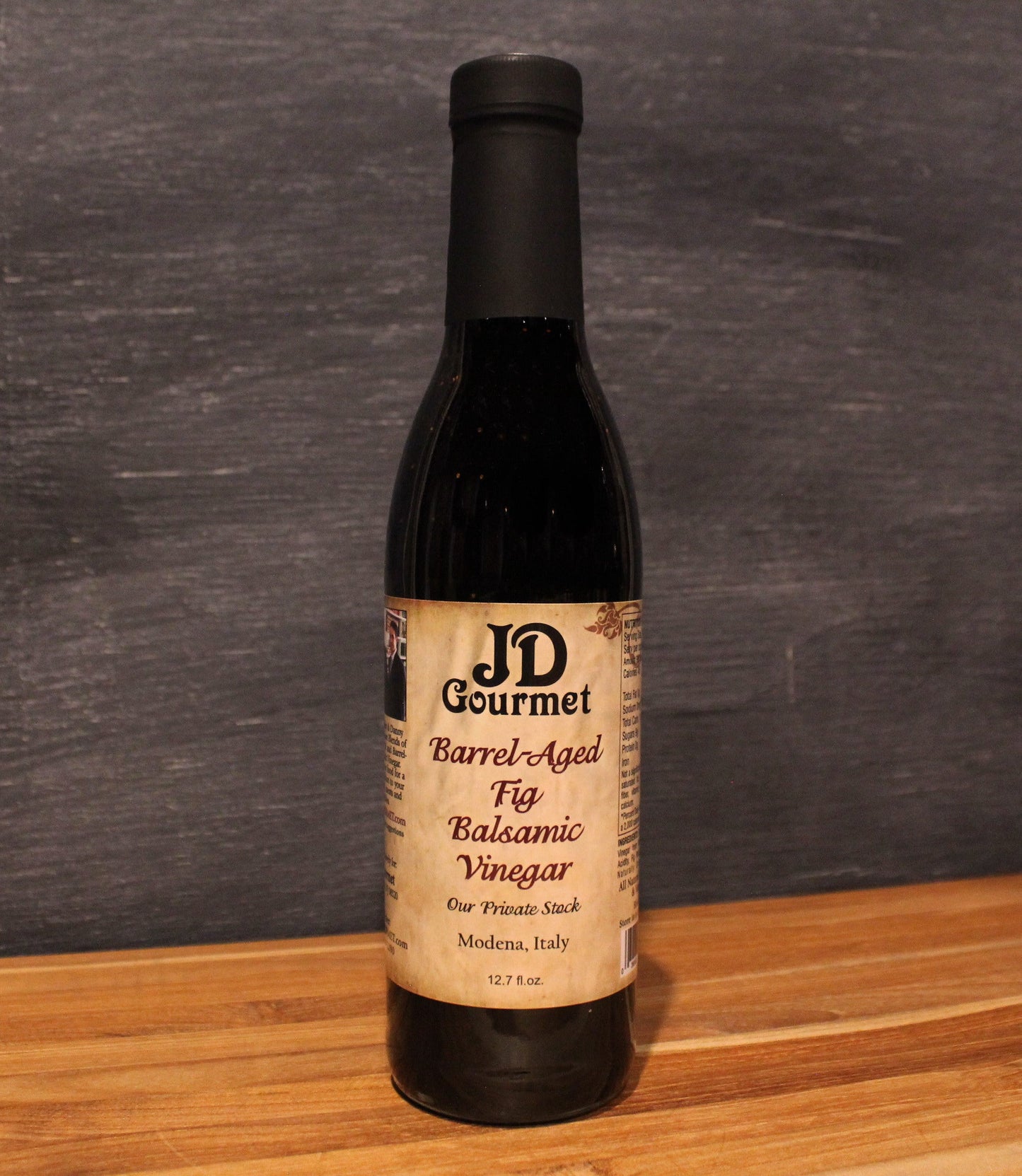 JD Gourmet Fig Balsamic Vinegar — dark balsamic in a clear glass bottle, made with Black Mission figs