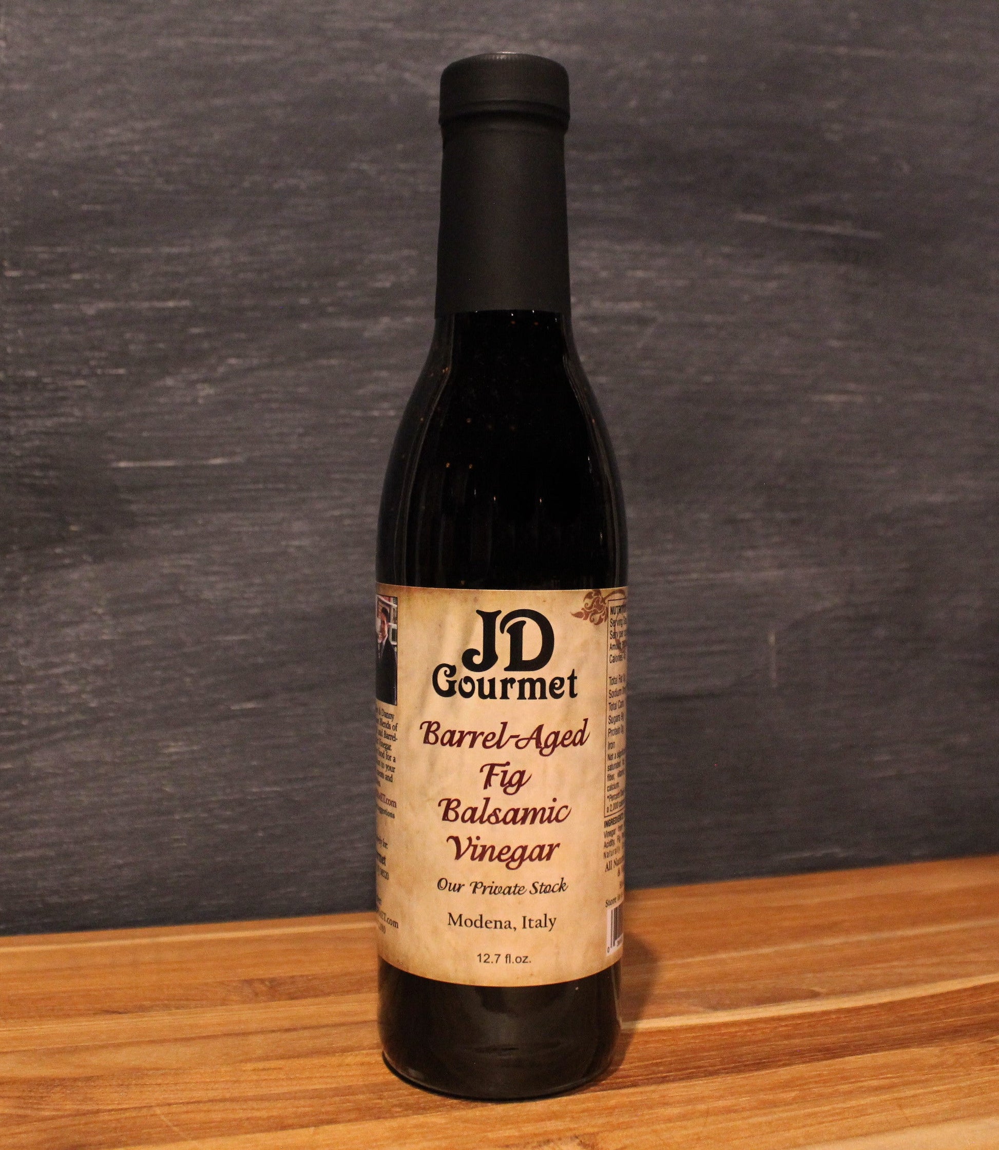 JD Gourmet Fig Balsamic Vinegar — dark balsamic in a clear glass bottle, made with Black Mission figs