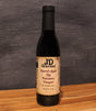 JD Gourmet Fig Balsamic Vinegar — dark balsamic in a clear glass bottle, made with Black Mission figs
