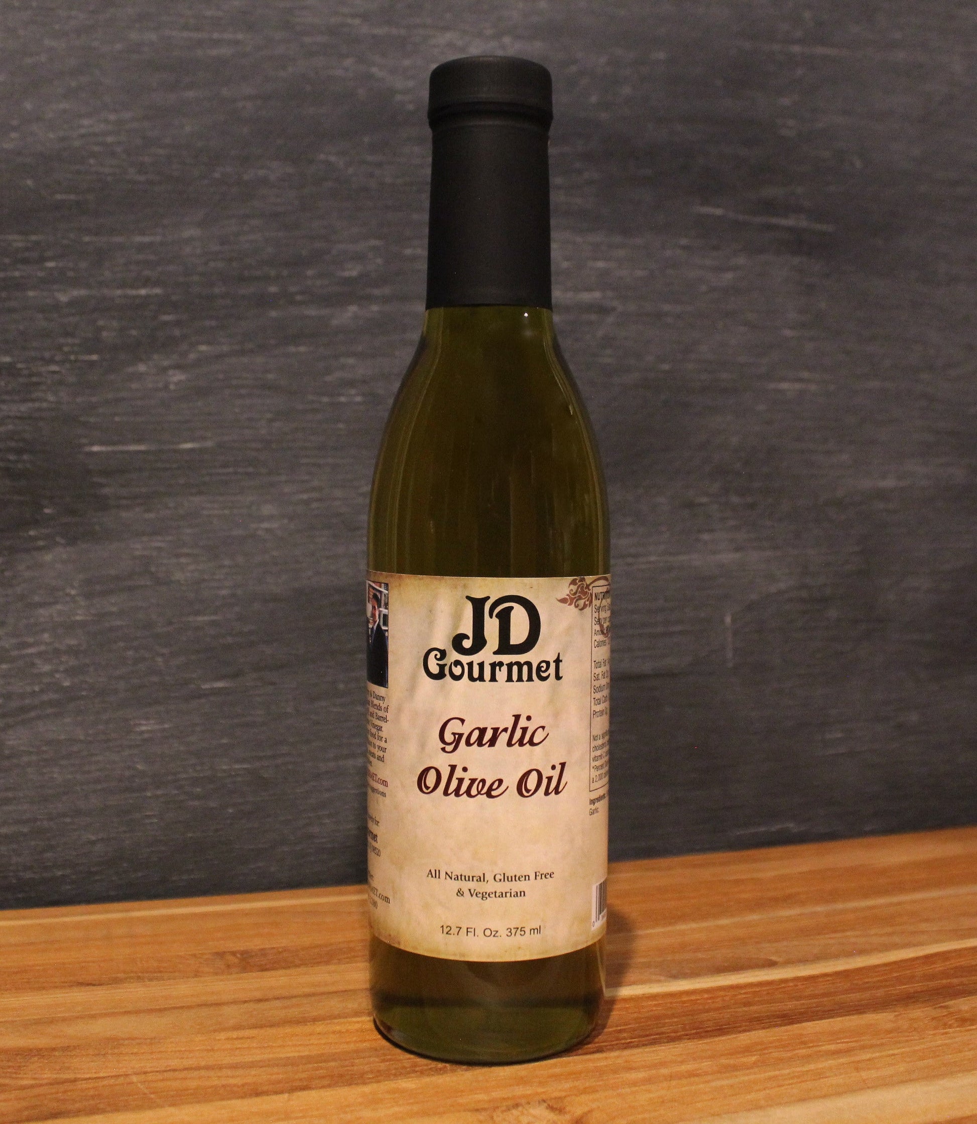 Bottle of JD Gourmet Garlic Olive Oil, roasted garlic infused olive oil