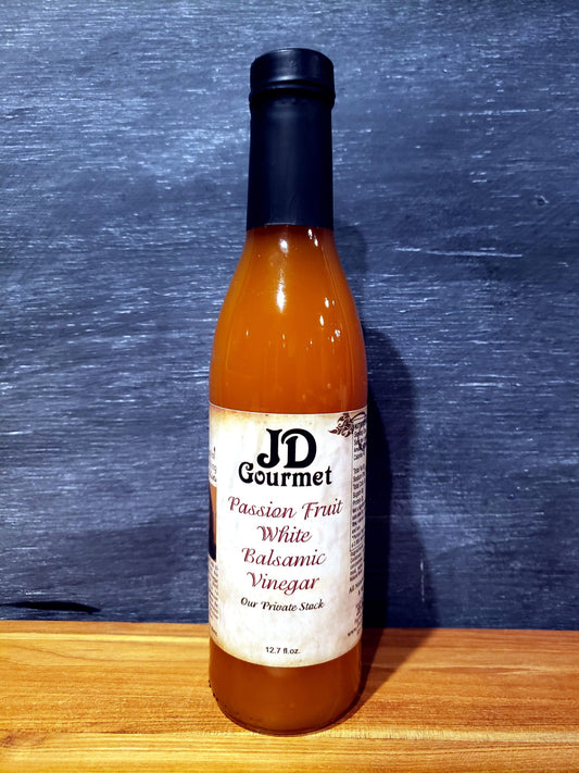 Clear bottle of JD Gourmet Passion Fruit White Balsamic Vinegar, golden Modena white balsamic with passion fruit