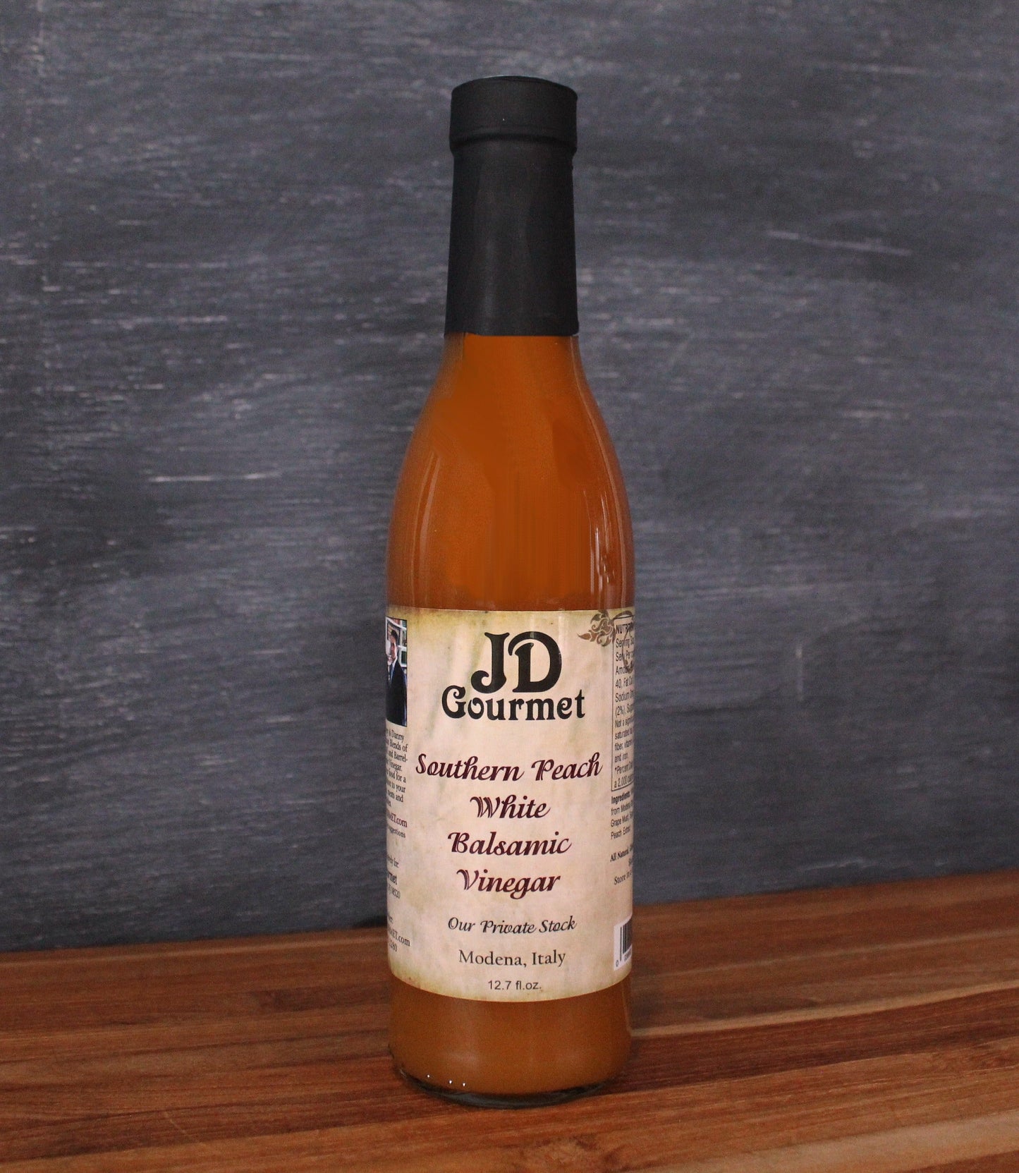 Bottle of JD Gourmet Southern Peach white balsamic vinegar, pale golden and bright
