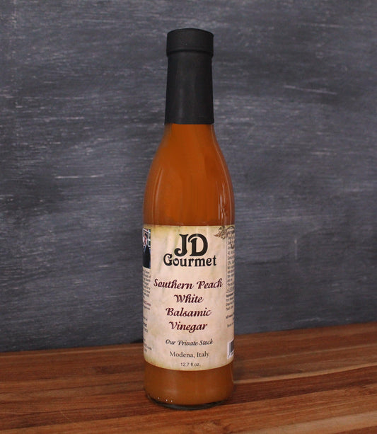 Bottle of JD Gourmet Southern Peach white balsamic vinegar, pale golden and bright