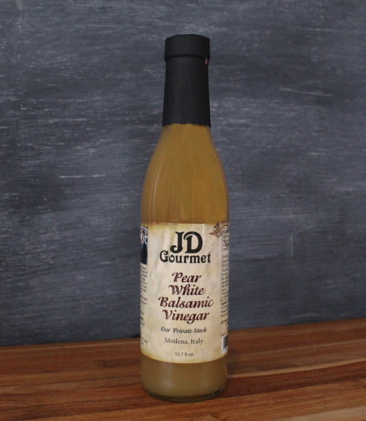 Clear bottle of JD Gourmet Pear White Balsamic Vinegar, golden Modena-sourced white balsamic with pear