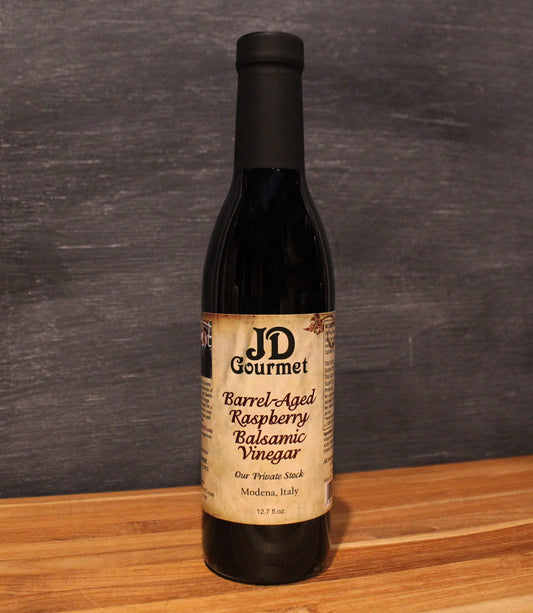 Bottle of JD Gourmet raspberry balsamic vinegar, deep red and glossy