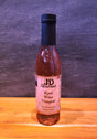 Bottle of JD Gourmet rosé wine vinegar, pale pink and bright