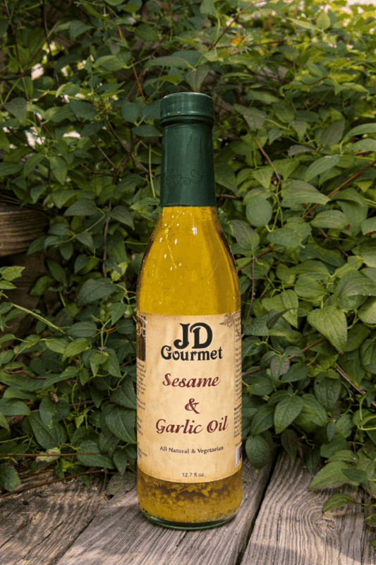 Bottle of JD Gourmet Sesame and Garlic olive oil blend, golden and savory