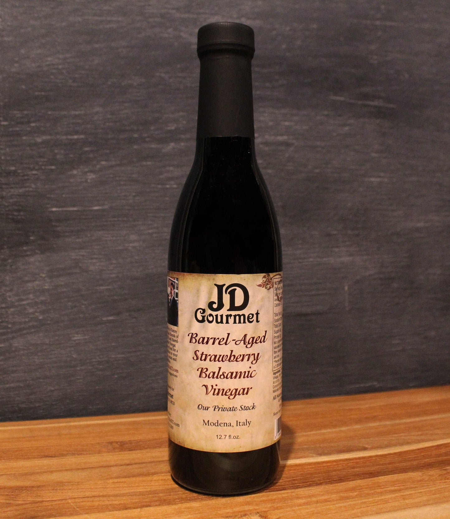 Bottle of JD Gourmet Strawberry Balsamic Vinegar, dark barrel-aged Modena balsamic with real strawberry