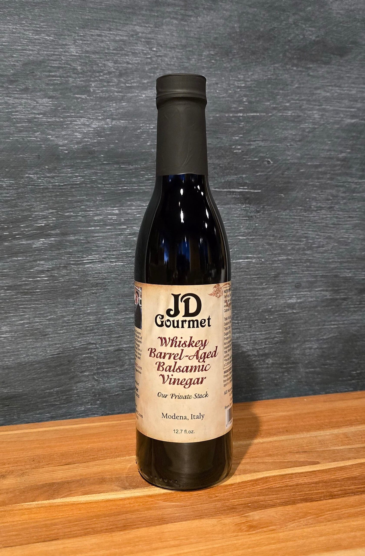 Bottle of JD Gourmet Whiskey Barrel Aged Balsamic Vinegar, Our Private Stock, dark traditional balsamic