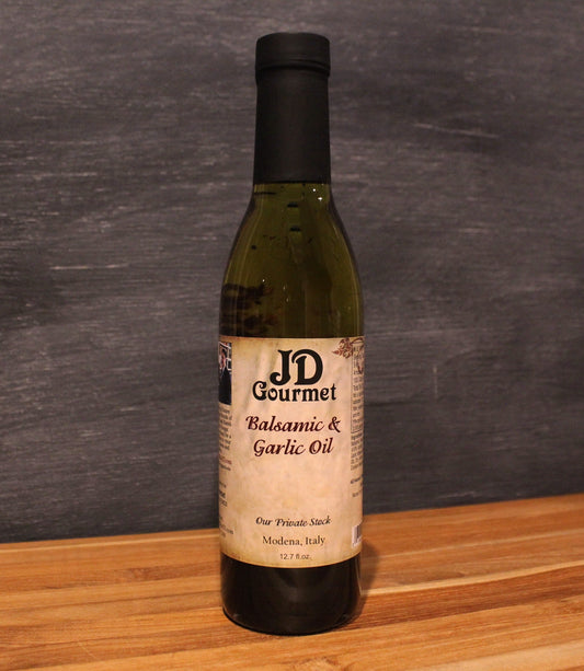 Bottle of JD Gourmet Balsamic Vinegar and Roasted Garlic Oil with chili and parsley