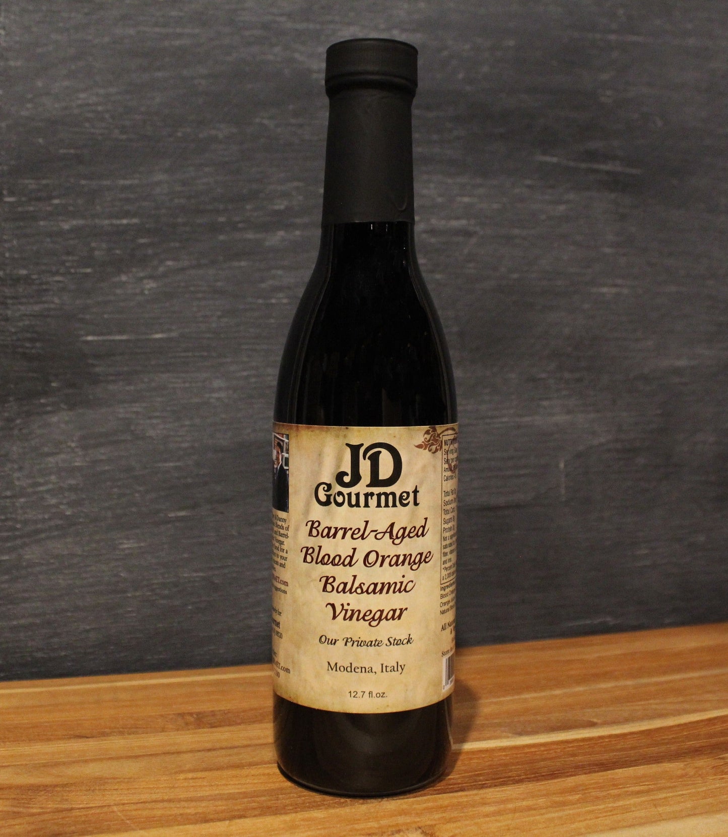 Bottle of JD Gourmet Blood Orange Balsamic Vinegar, a fruit-infused Modena balsamic