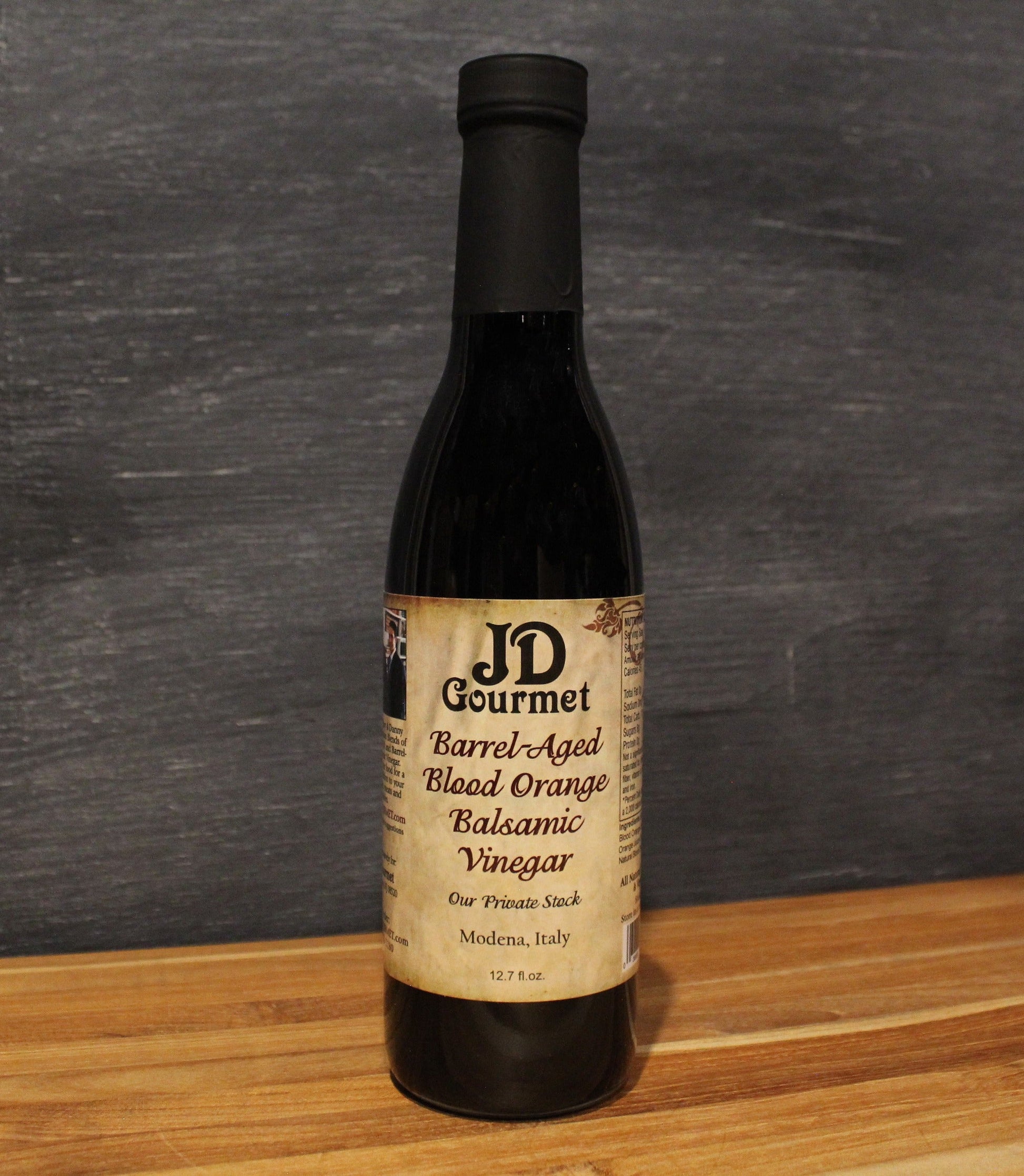 Bottle of JD Gourmet Blood Orange Balsamic Vinegar, a fruit-infused Modena balsamic